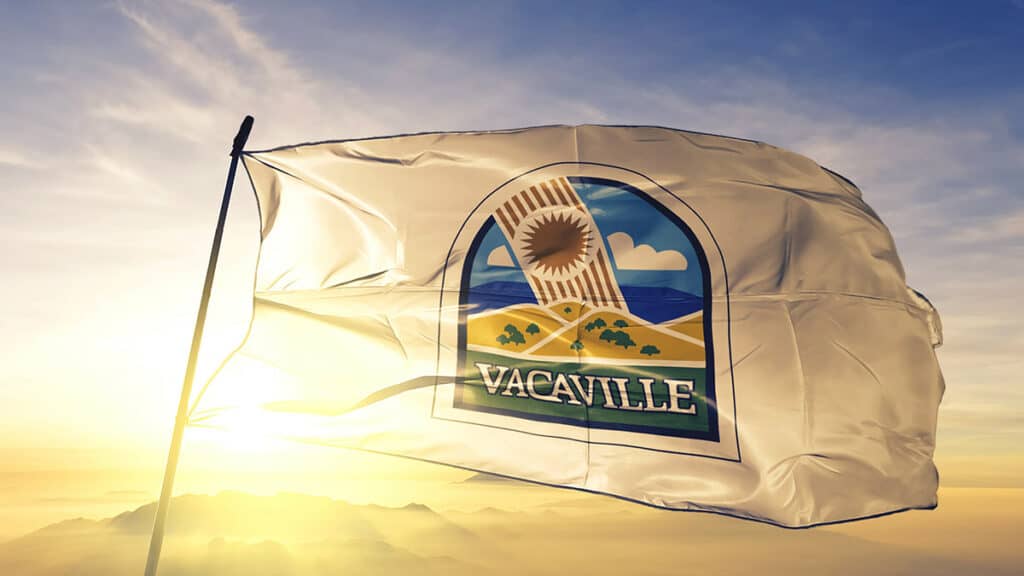 A Vacaville, CA flag flies in the wind over California.