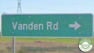 A green Vanden Road sign.